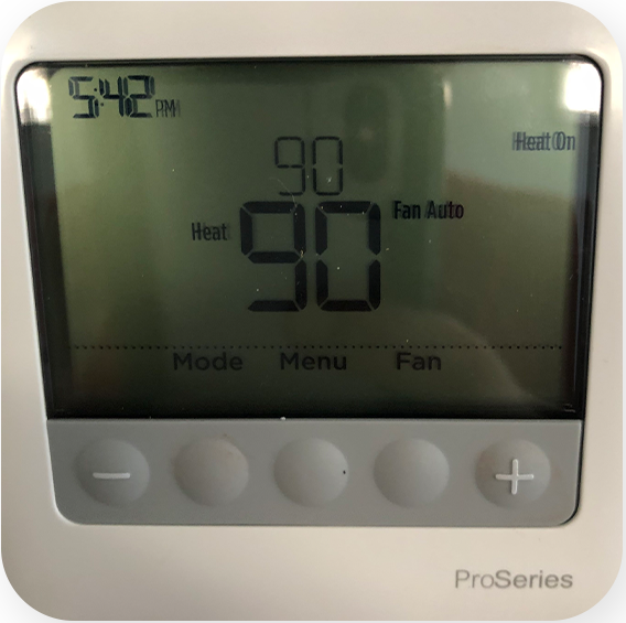 Thermostat in need of HVAC repair showing 90 degree temperature